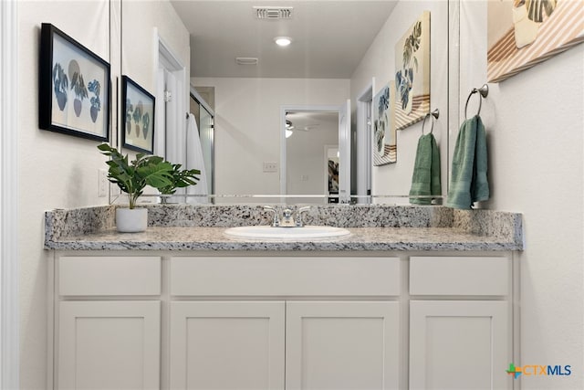 bathroom featuring vanity and ceiling fan