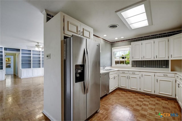kitchen featuring visible vents, built in shelves, appliances with stainless steel finishes, and light countertops
