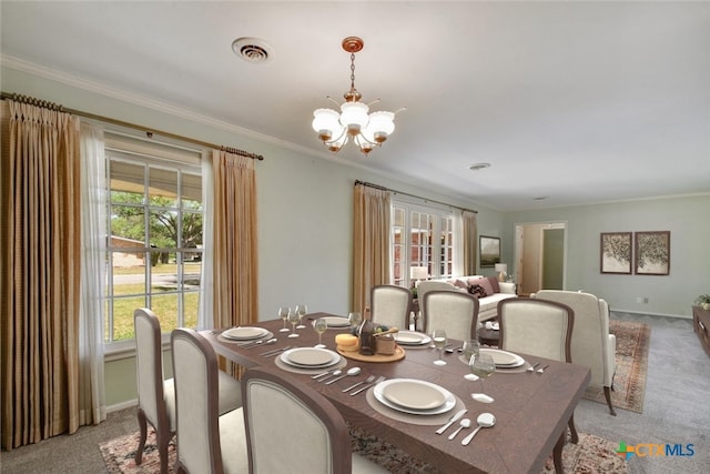 dining area with a chandelier, plenty of natural light, and light colored carpet