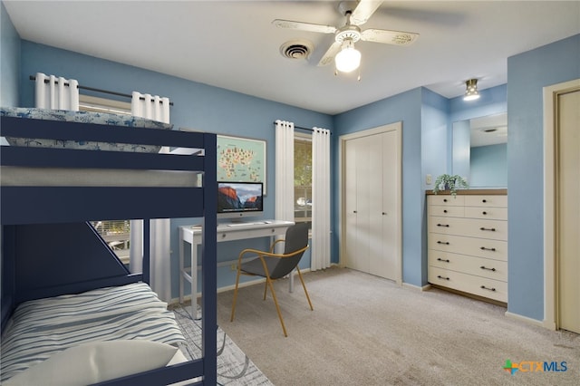 carpeted bedroom featuring visible vents, baseboards, and ceiling fan