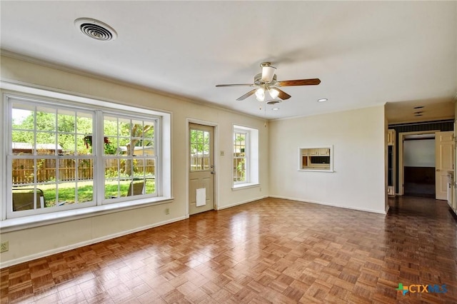unfurnished living room featuring visible vents, ceiling fan, and baseboards