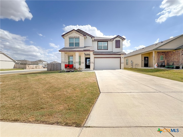 view of front of property featuring a garage and a front yard