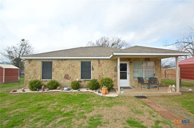 rear view of house featuring a yard