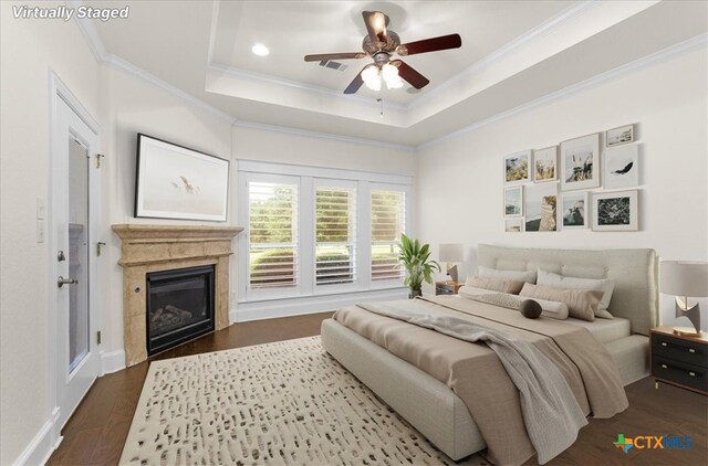 2901 Chisholm Trl, Salado, TX 76571 - bedroom with crown molding, a raised ceiling, a high end fireplace, dark wood-type flooring, and a ceiling fan