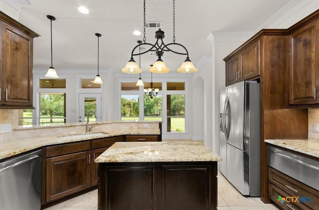 2901 Chisholm Trl, Salado, TX 76571 - kitchen featuring appliances with stainless steel finishes, a warming drawer, tasteful backsplash, light tile patterned floors, and light stone counters