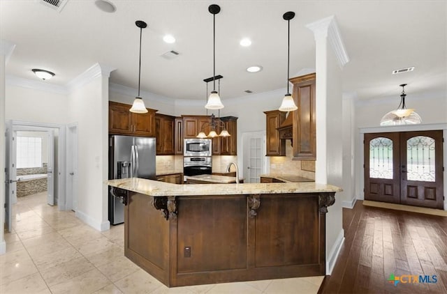 2901 Chisholm Trl, Salado, TX 76571 - kitchen with stainless steel appliances, ornamental molding, light stone countertops, decorative backsplash, and a peninsula