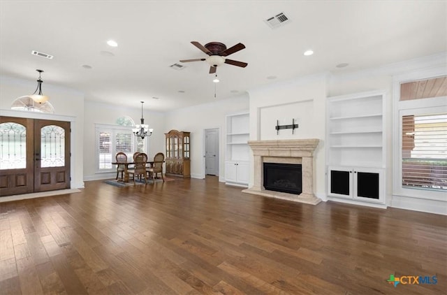 2901 Chisholm Trl, Salado, TX 76571 - living room with french doors, built in features, ceiling fan, wood finished floors, and a chandelier