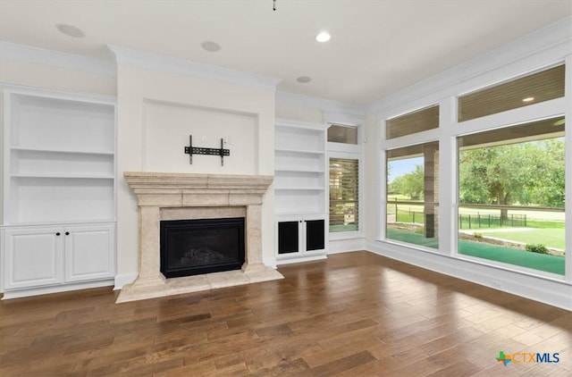 2901 Chisholm Trl, Salado, TX 76571 - unfurnished living room with ornamental molding, built in features, a premium fireplace, and wood finished floors