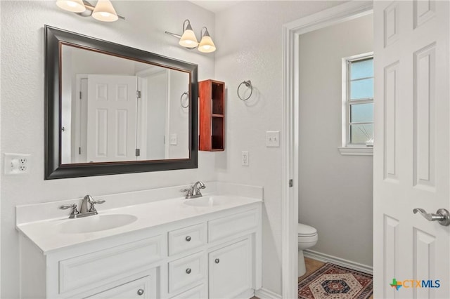 bathroom with toilet and vanity