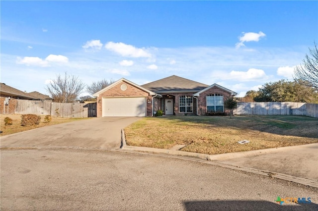 single story home featuring a garage and a front yard