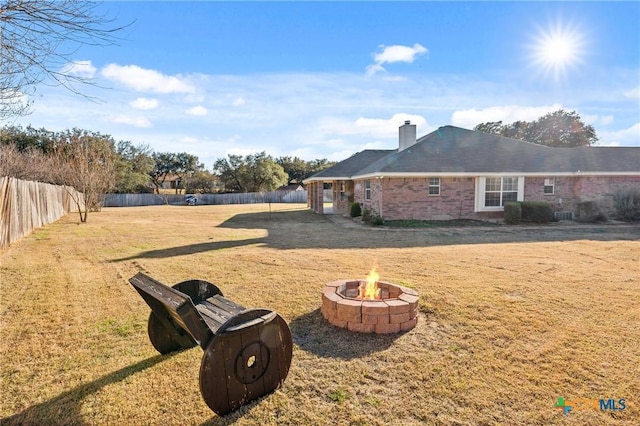 view of yard with an outdoor fire pit