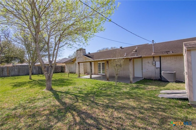 back of house with a patio, french doors, a lawn, and a fenced backyard