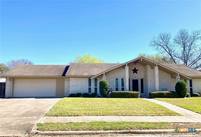 mid-century inspired home with brick siding, an attached garage, concrete driveway, and a front yard