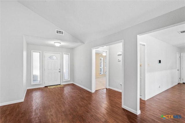 entrance foyer featuring visible vents, lofted ceiling, baseboards, and wood finished floors