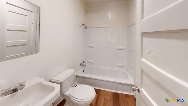 full bathroom with hardwood / wood-style floors, shower / bath combination, sink, and toilet