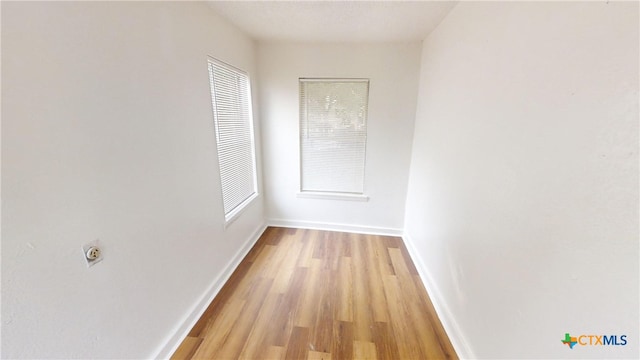 hallway featuring plenty of natural light and light wood-type flooring