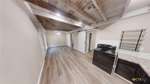 basement with light hardwood / wood-style floors, a barn door, ceiling fan, and wood ceiling