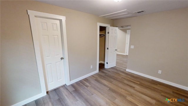 unfurnished bedroom featuring light wood-type flooring and a closet