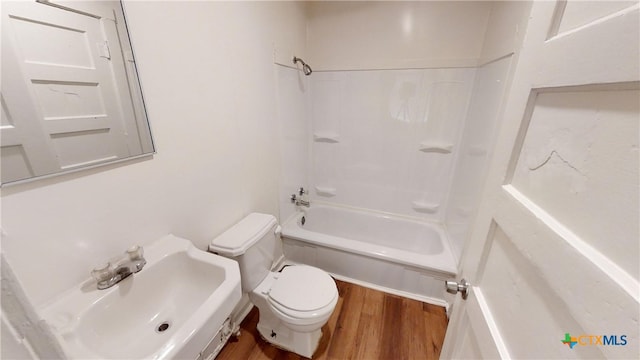 full bathroom featuring toilet, hardwood / wood-style flooring, sink, and bathtub / shower combination