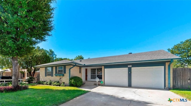 single story home featuring a front yard and a garage