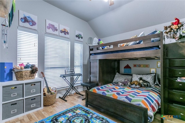 bedroom with light hardwood / wood-style floors, lofted ceiling, and ceiling fan