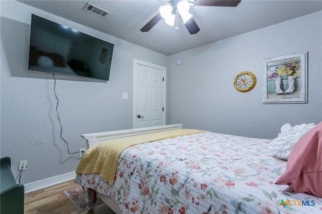 bedroom featuring ceiling fan and hardwood / wood-style flooring