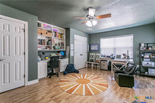 office featuring ceiling fan, a textured ceiling, and light wood-type flooring