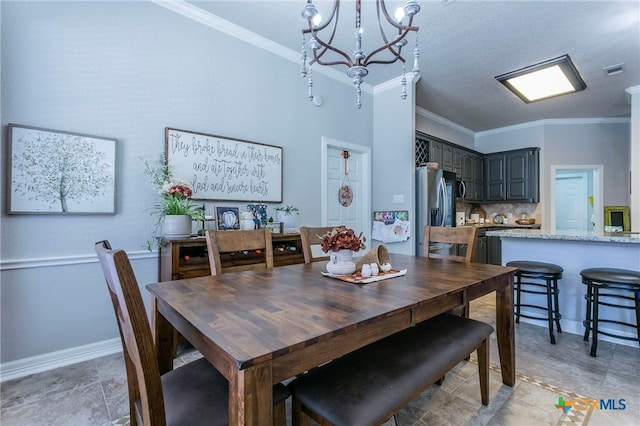 dining area featuring crown molding, a chandelier, and a textured ceiling