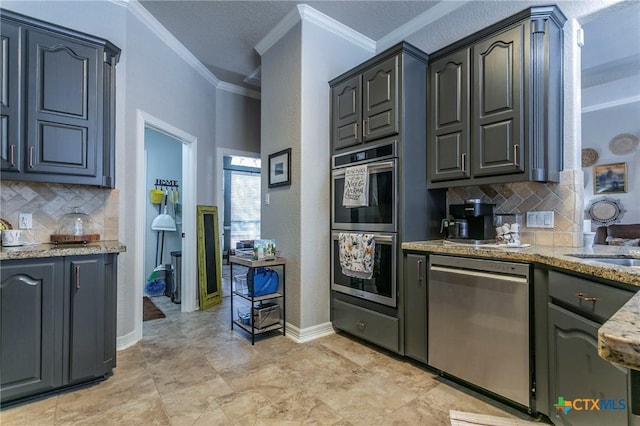 kitchen with appliances with stainless steel finishes, ornamental molding, backsplash, and light stone countertops