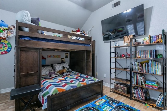 bedroom featuring vaulted ceiling and hardwood / wood-style flooring