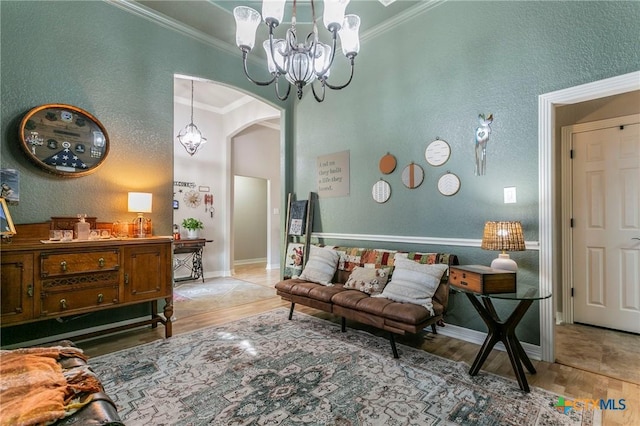 living room featuring a chandelier, crown molding, and hardwood / wood-style flooring