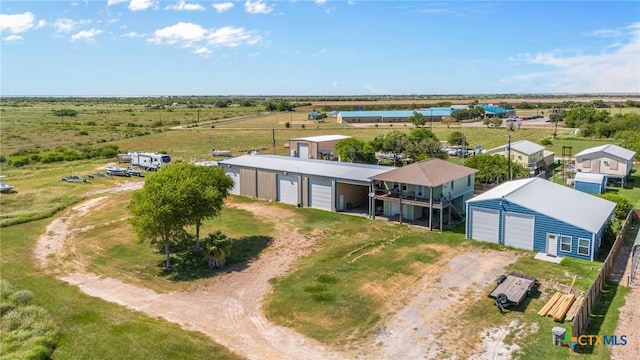 birds eye view of property with a rural view