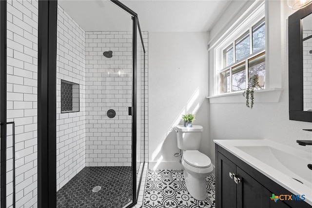 full bathroom featuring tile patterned floors, toilet, a stall shower, and vanity