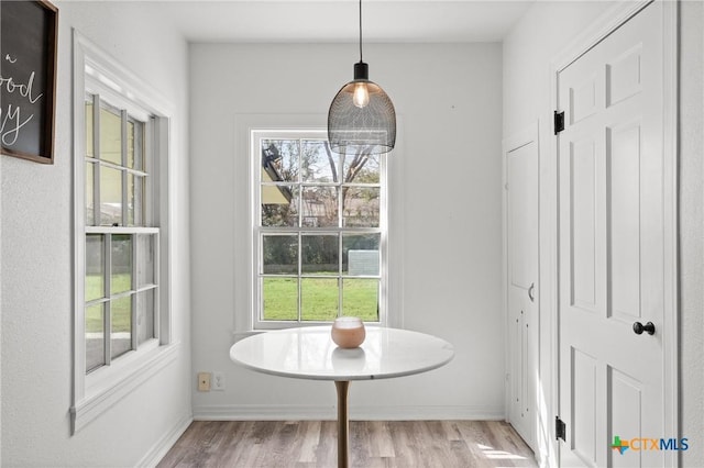 dining area with wood finished floors and baseboards