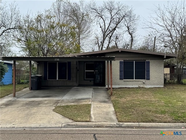 view of front facade with a carport and a front lawn