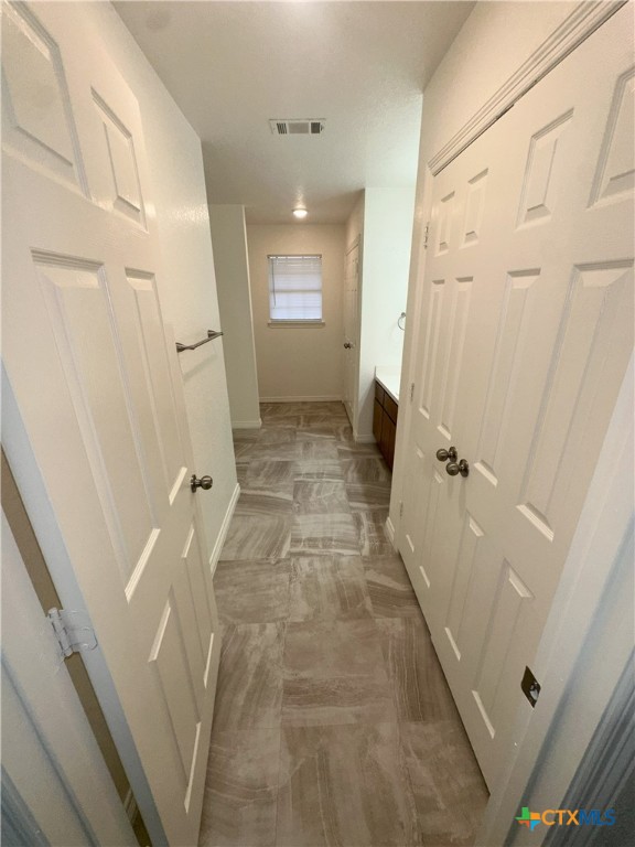 hall featuring baseboards