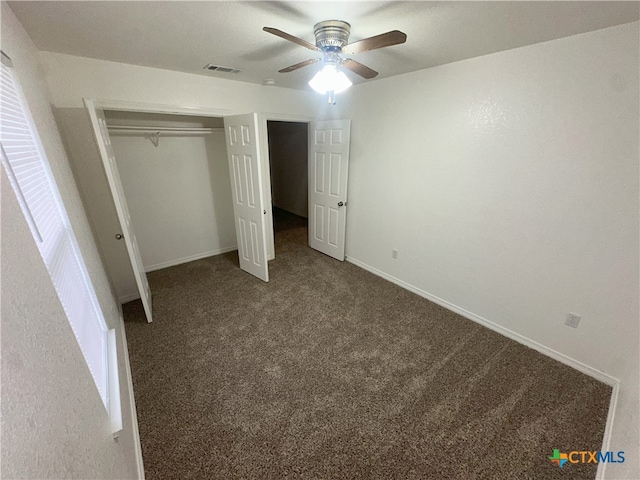 unfurnished bedroom with carpet floors, a closet, baseboards, and ceiling fan