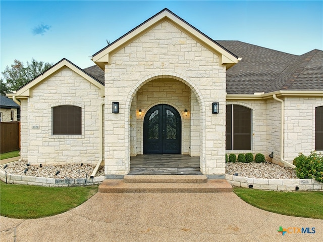 1127 Redleaf Dr, Nolanville, TX 76559 - view of front of home with french doors, stone siding, and a shingled roof