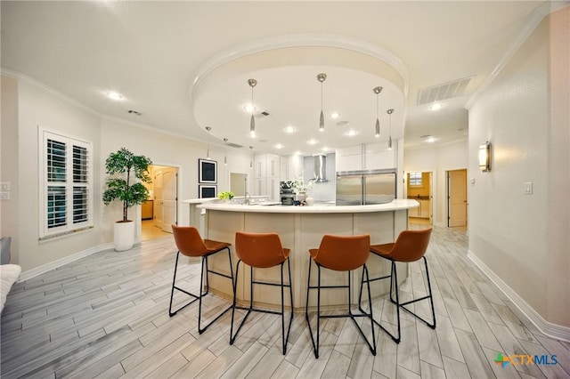 1127 Redleaf Dr, Nolanville, TX 76559 - kitchen with stainless steel built in refrigerator, ornamental molding, light wood finished floors, baseboards, and wall chimney range hood