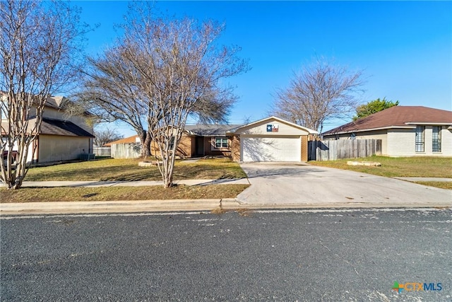 ranch-style home featuring a garage and a front lawn