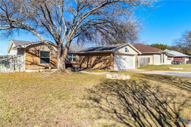 ranch-style home featuring a front lawn and a garage