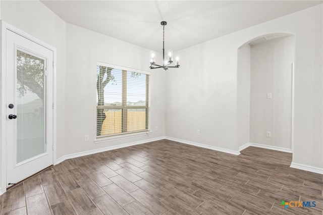 unfurnished dining area with an inviting chandelier