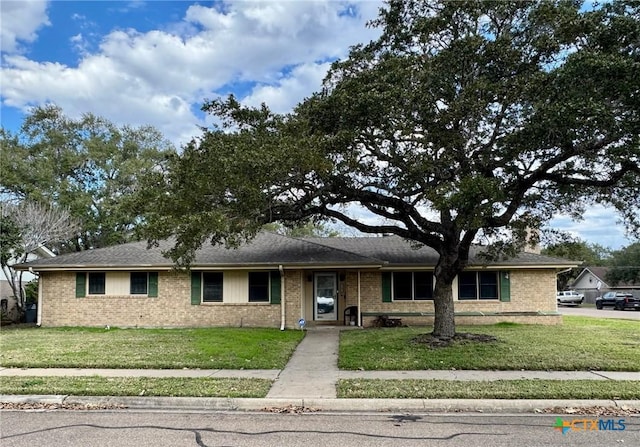 ranch-style house with a front lawn