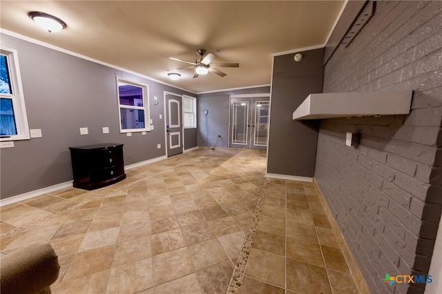 unfurnished living room featuring ornamental molding, brick wall, and ceiling fan