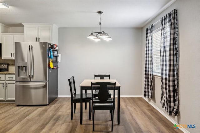 2617 Turning Creek St, Temple, TX 76504 - dining room with wood finished floors and a chandelier