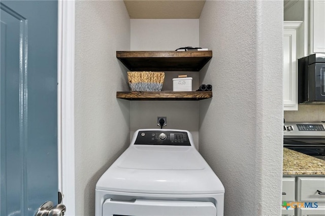 2617 Turning Creek St, Temple, TX 76504 - laundry room featuring washer / dryer and a textured wall