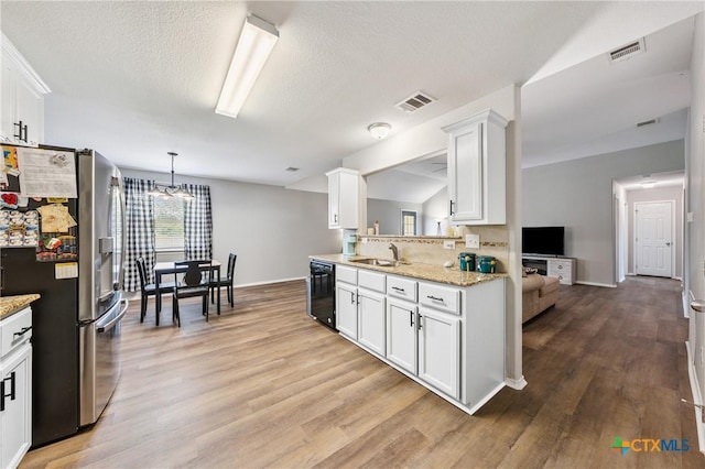 2617 Turning Creek St, Temple, TX 76504 - kitchen featuring stainless steel refrigerator with ice dispenser, light wood-type flooring, white cabinetry, a chandelier, and hanging light fixtures