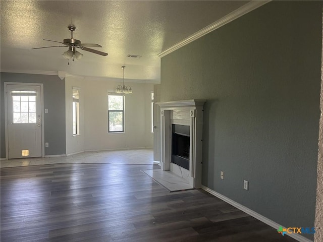 508 Redbud Dr, Copperas Cove, TX 76522 - unfurnished living room featuring crown molding, healthy amount of natural light, ceiling fan, wood finished floors, and a textured ceiling