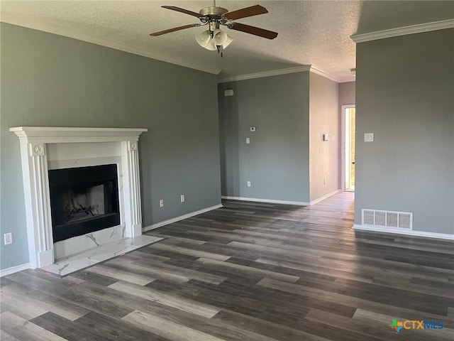 508 Redbud Dr, Copperas Cove, TX 76522 - unfurnished living room featuring dark wood-style flooring, ceiling fan, a textured ceiling, ornamental molding, and a premium fireplace