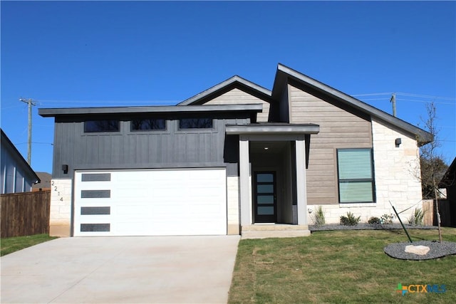 contemporary house with a garage and a front lawn